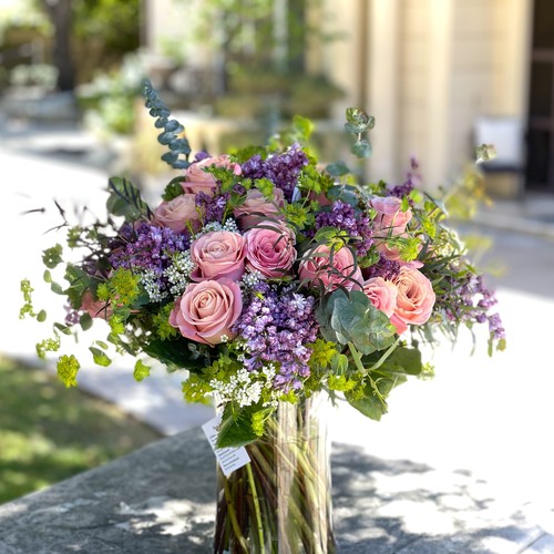 Dusty pink roses with purple lilac and eucalyptus in a glass vase from luxury floral design Durham